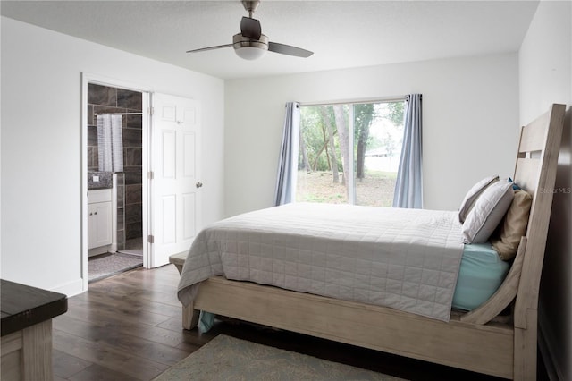 bedroom featuring ceiling fan, dark wood-type flooring, and ensuite bath