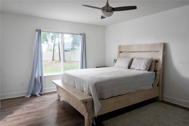 bedroom with ceiling fan and dark hardwood / wood-style floors