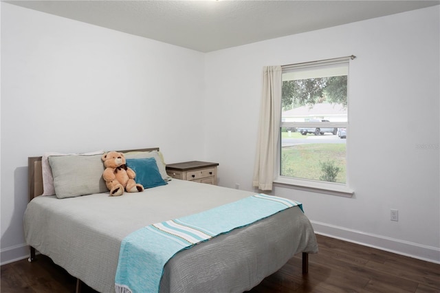 bedroom with dark wood-type flooring