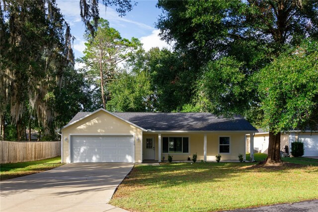 ranch-style home with a front lawn and a garage