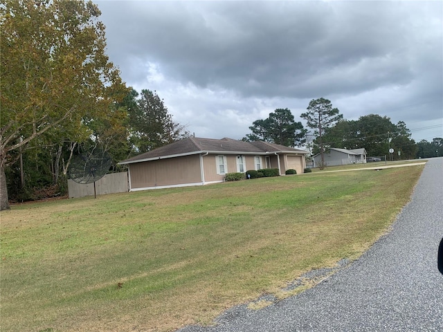 view of front of home featuring a garage and a front lawn