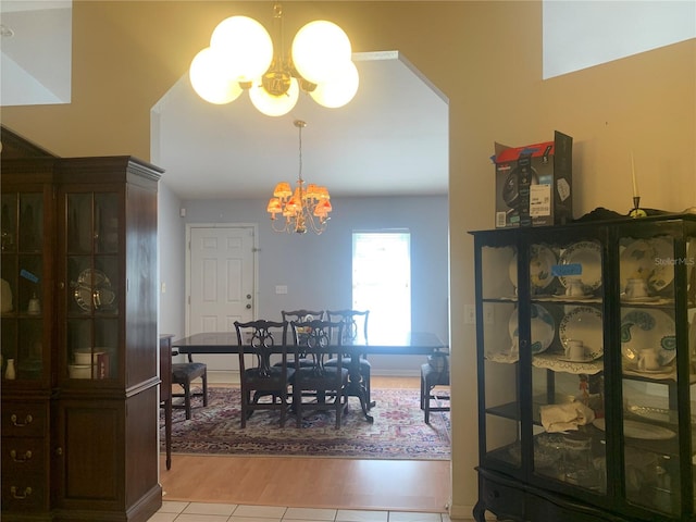 dining room featuring light tile patterned floors and a notable chandelier