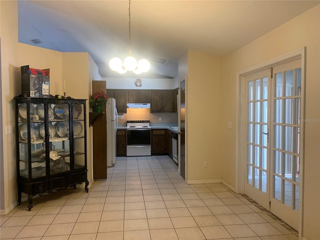 kitchen with tasteful backsplash, dark brown cabinets, white appliances, light tile patterned floors, and a chandelier