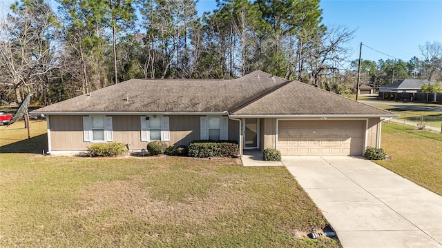 ranch-style home with a shingled roof, concrete driveway, an attached garage, and a front lawn