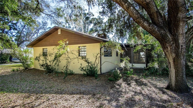 view of side of property featuring a sunroom