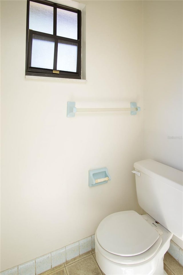 bathroom featuring tile patterned flooring and toilet