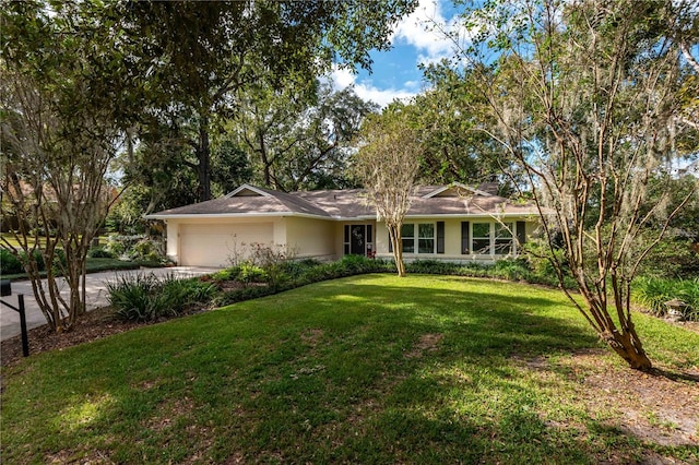 single story home featuring a front lawn and a garage