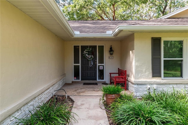 view of exterior entry with a porch