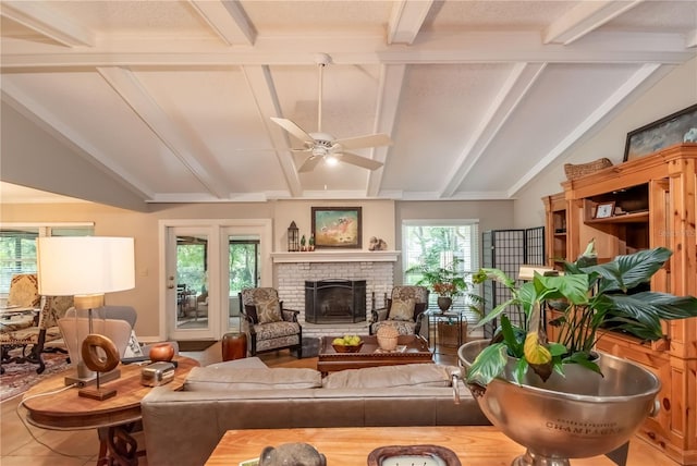 living room featuring ceiling fan, lofted ceiling with beams, a textured ceiling, and a brick fireplace