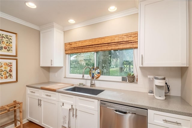 kitchen featuring dishwasher, white cabinetry, crown molding, and sink