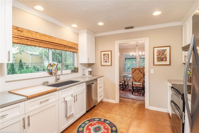 kitchen featuring stainless steel dishwasher, white cabinetry, sink, and a wealth of natural light