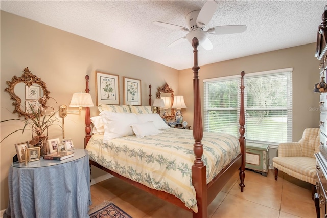 tiled bedroom with ceiling fan and a textured ceiling