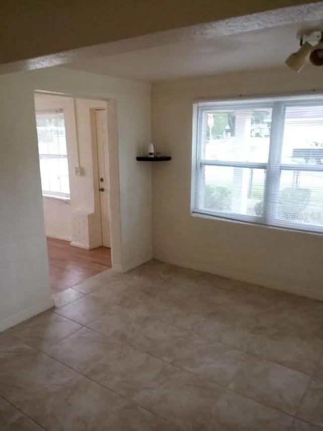 unfurnished room with light tile patterned floors