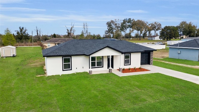 view of front of home featuring a shingled roof, a front yard, concrete driveway, and a garage