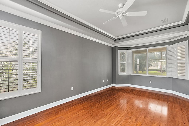 spare room with ceiling fan, wood-type flooring, and crown molding