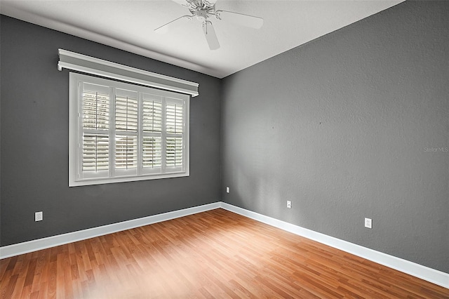 unfurnished room with hardwood / wood-style floors and ceiling fan