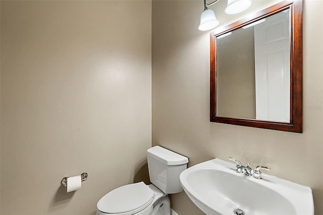 bathroom featuring toilet and sink