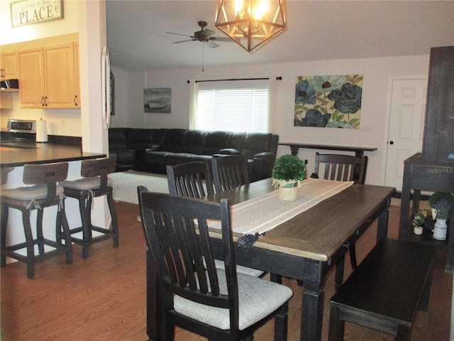 dining space featuring dark hardwood / wood-style floors and ceiling fan with notable chandelier