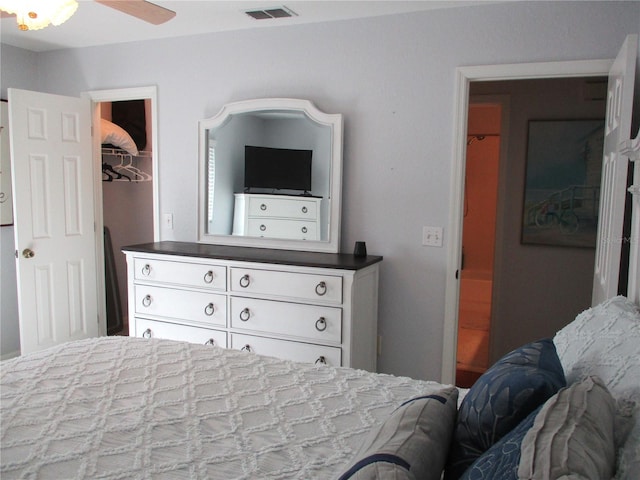 bedroom featuring ceiling fan, a spacious closet, and a closet