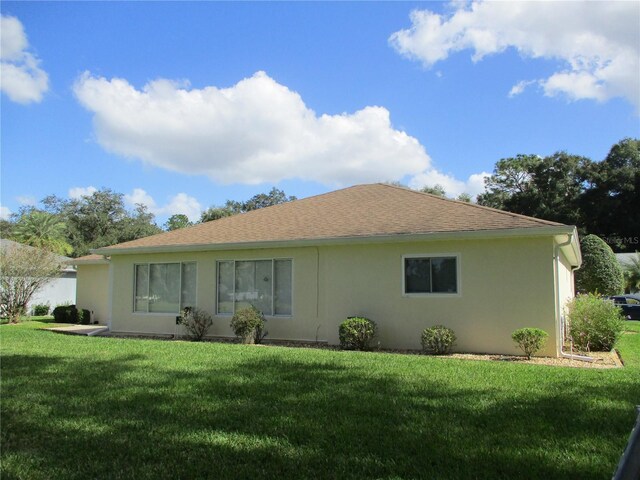 rear view of property featuring a yard