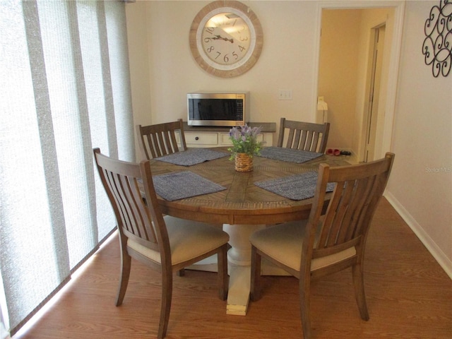 dining room with hardwood / wood-style flooring