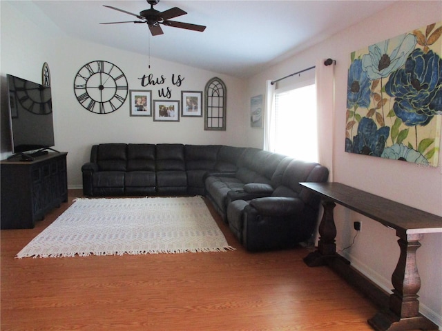 living room with ceiling fan, hardwood / wood-style floors, and lofted ceiling