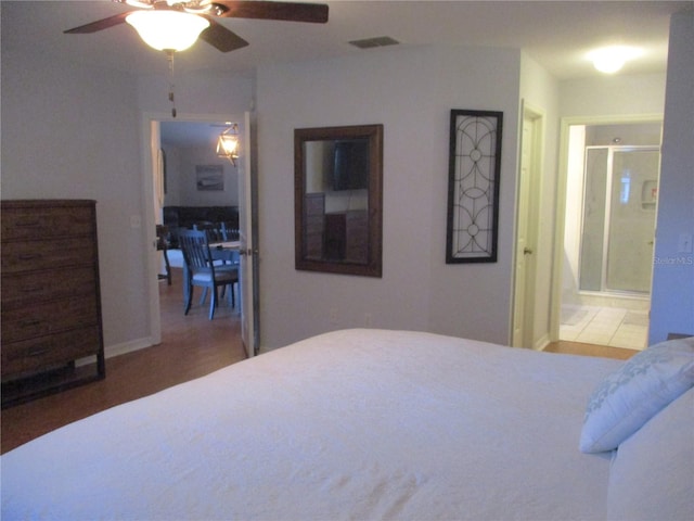 bedroom featuring wood-type flooring, connected bathroom, and ceiling fan