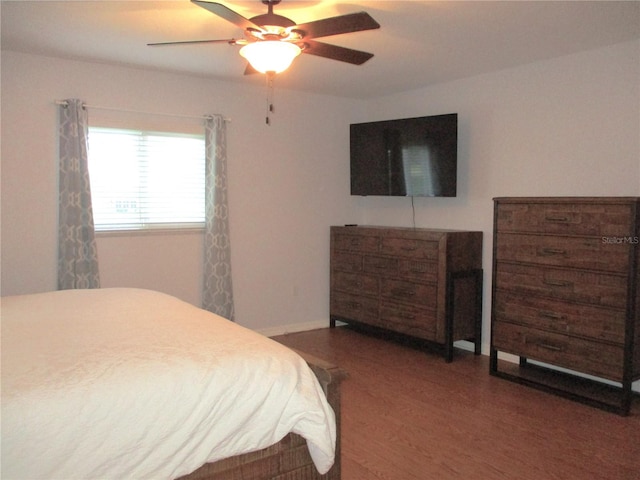 bedroom featuring ceiling fan and dark hardwood / wood-style floors