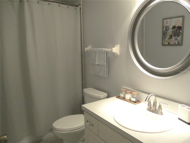 bathroom featuring vanity and toilet