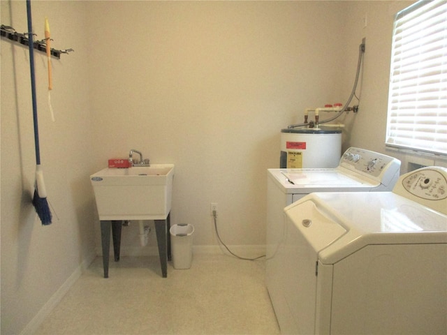 laundry area featuring electric water heater and washer and dryer