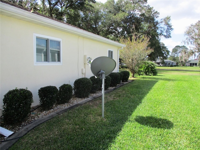 view of property exterior with a lawn