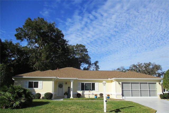 ranch-style house with a garage and a front yard