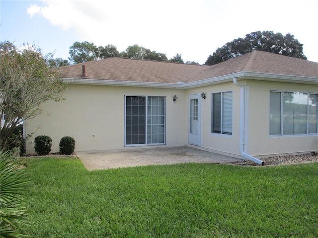 rear view of property with a lawn and a patio area