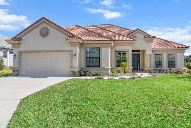 mediterranean / spanish home with a front lawn and a garage