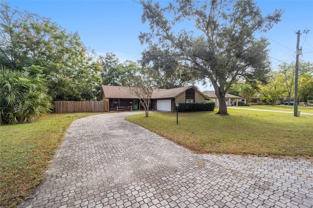 ranch-style house featuring a front lawn and a garage