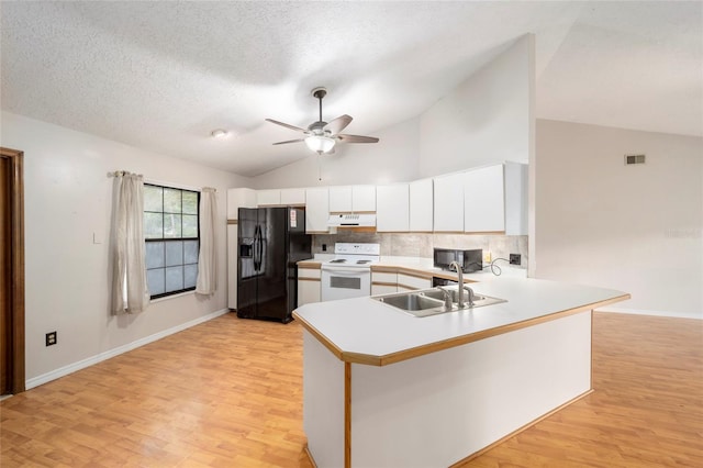 kitchen with kitchen peninsula, light hardwood / wood-style flooring, black appliances, and sink