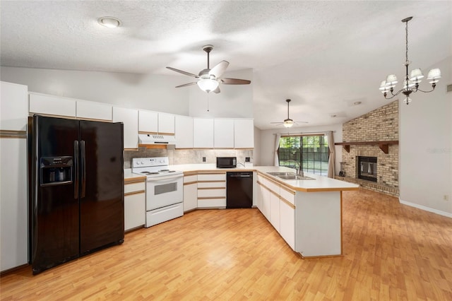 kitchen with sink, black appliances, kitchen peninsula, white cabinets, and light wood-type flooring