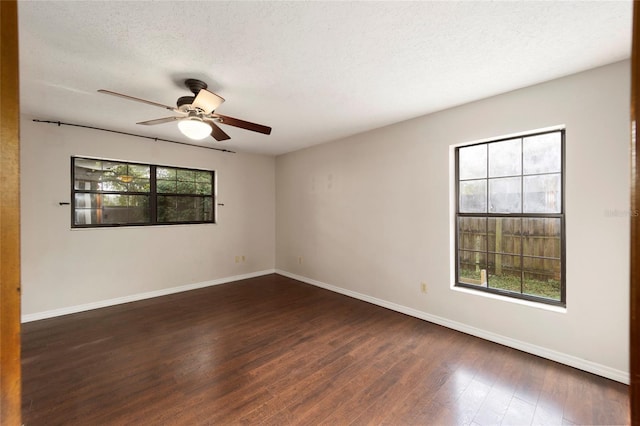 spare room with dark hardwood / wood-style flooring, a textured ceiling, and ceiling fan