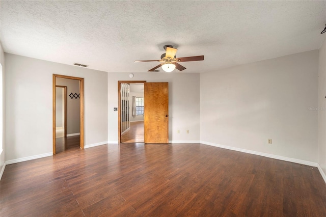 empty room with dark wood-type flooring, a textured ceiling, and ceiling fan