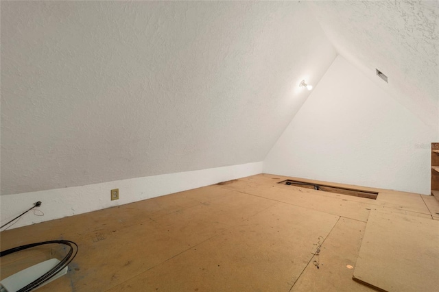 interior space featuring lofted ceiling and a textured ceiling