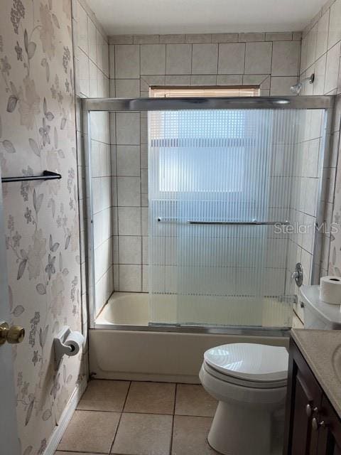 full bathroom with vanity, enclosed tub / shower combo, tile patterned floors, and toilet