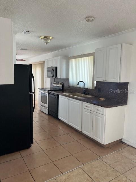 kitchen with light tile patterned flooring, white cabinetry, sink, black appliances, and a textured ceiling