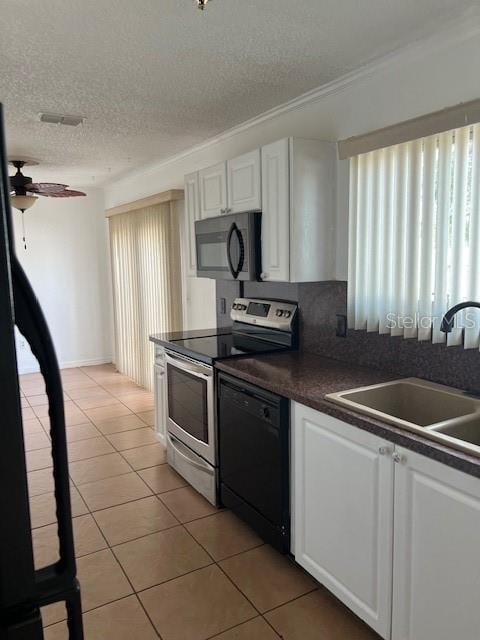 kitchen with sink, appliances with stainless steel finishes, tasteful backsplash, light tile patterned floors, and white cabinets