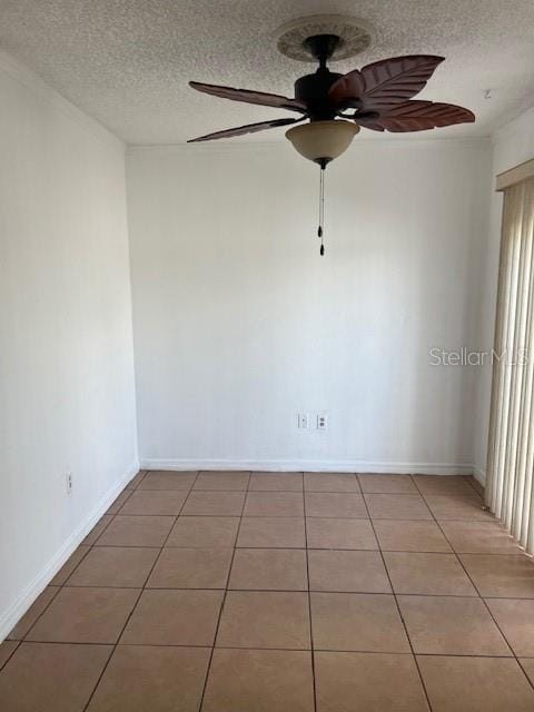 tiled spare room with ceiling fan and a textured ceiling