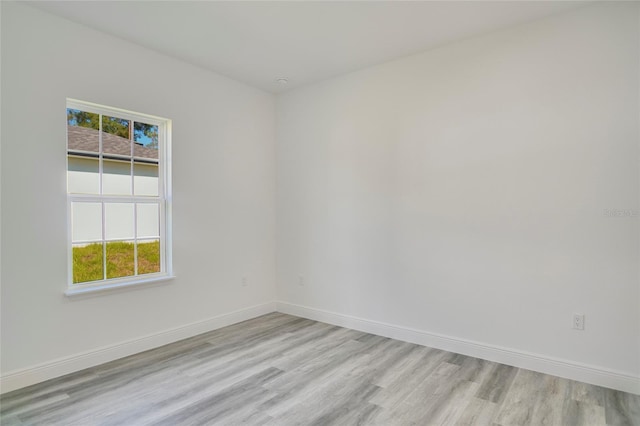 spare room with light hardwood / wood-style flooring