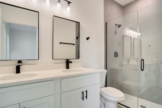 bathroom featuring toilet, vanity, and an enclosed shower