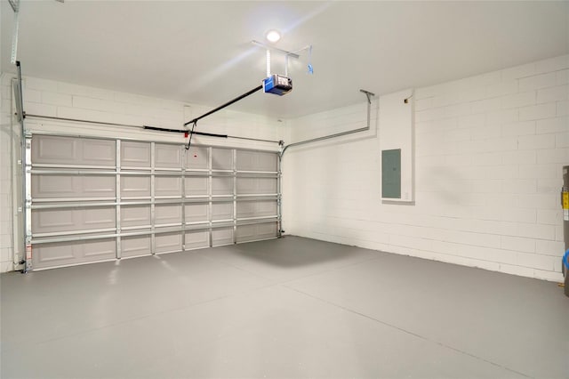 garage featuring a garage door opener and electric panel