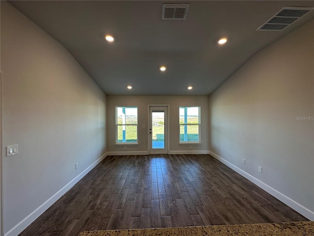 unfurnished room with dark wood-type flooring