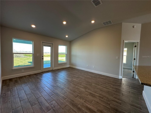 empty room with dark hardwood / wood-style floors and lofted ceiling