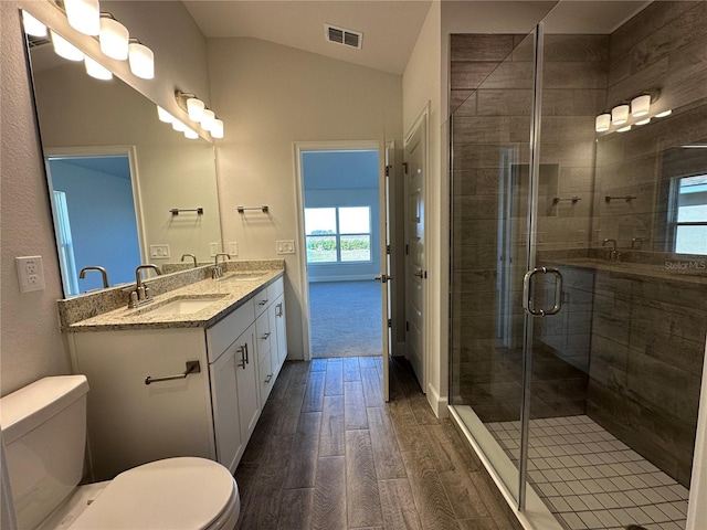 4489 SW 90th Pl, Ocala, FL 34476 - full bath with toilet, wood finished floors, double vanity, vaulted ceiling, and a shower stall